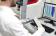 Lab technician loading slides on a Leica BOND RXm staining system